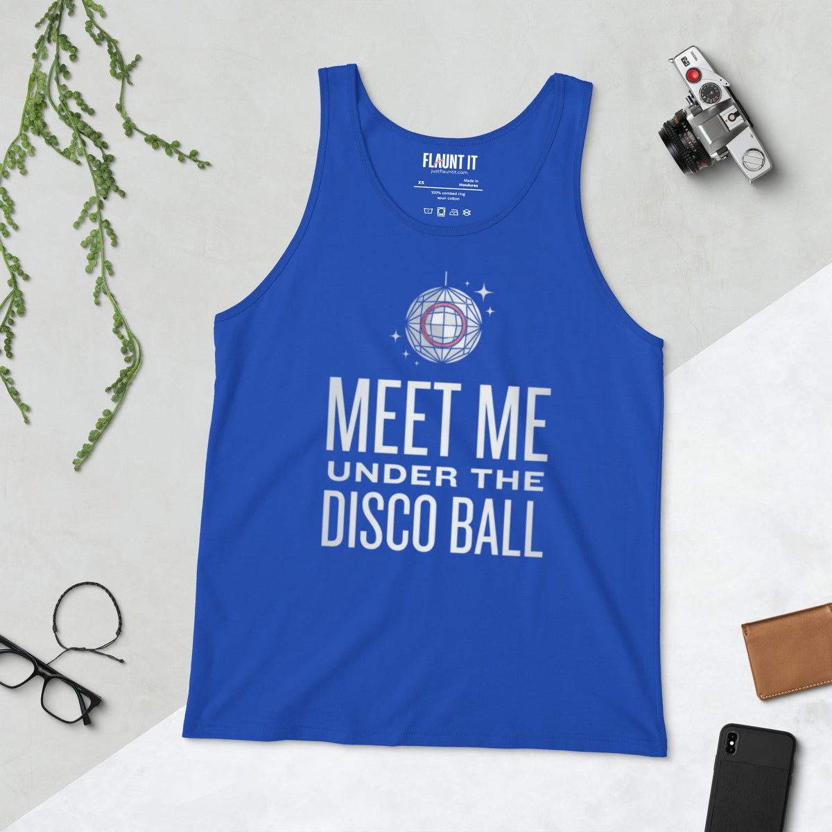 Flaunt It blue cotton tank top with Meet Me Under the Disco Ball graphic, laid flat with camera and glasses.