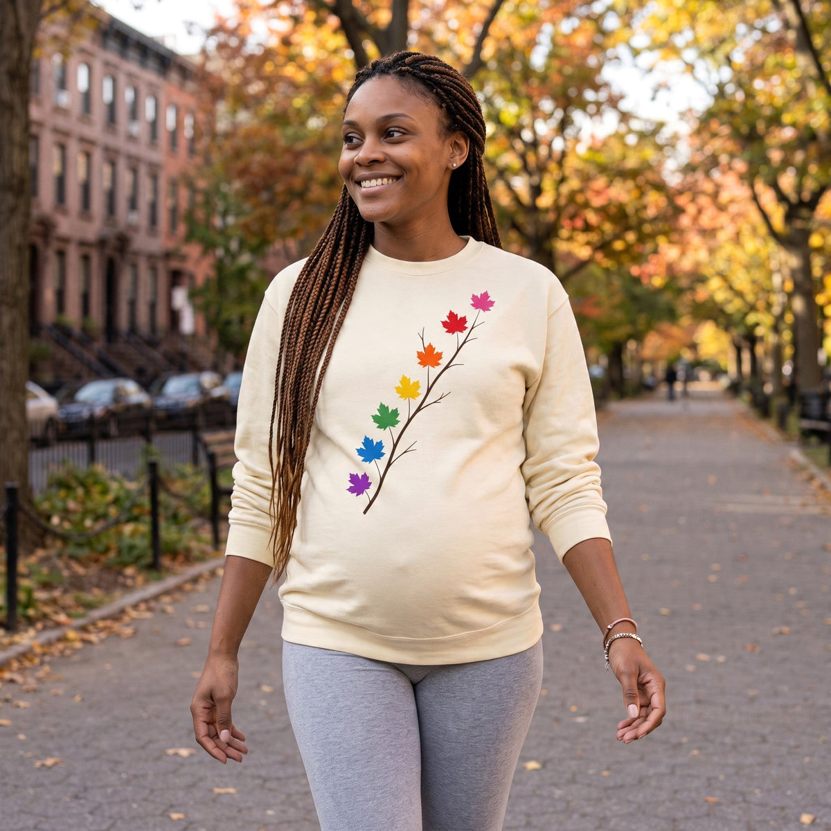 Flaunt It cream heavyweight long sleeve shirt with a diagonal branch graphic featuring colorful pride maple leaves