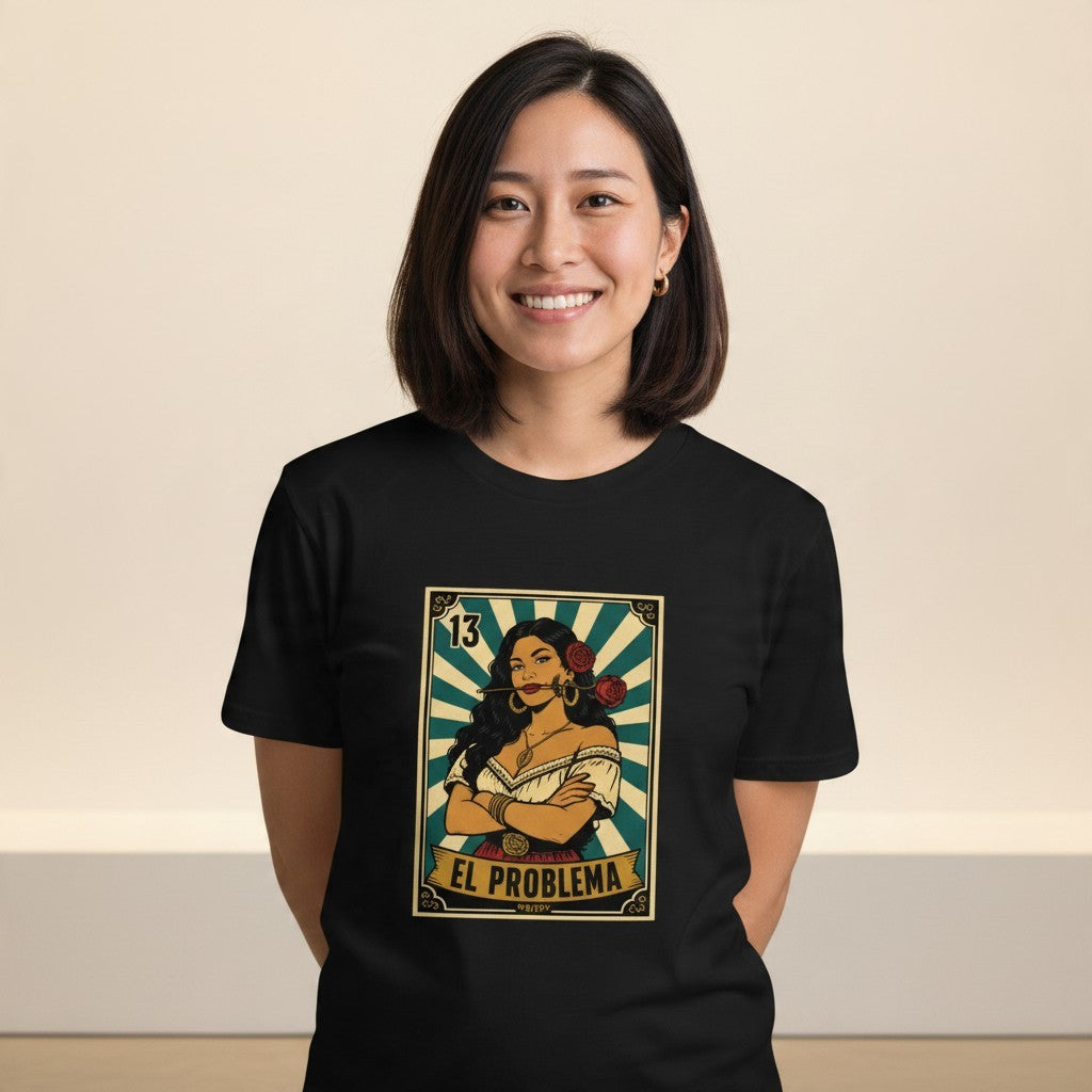 Close-up front view of a smiling female model wearing the black El Problema Premium Unisex T-Shirt with a vintage loteria card design of a woman with roses, EL PROBLEMA text and number 13