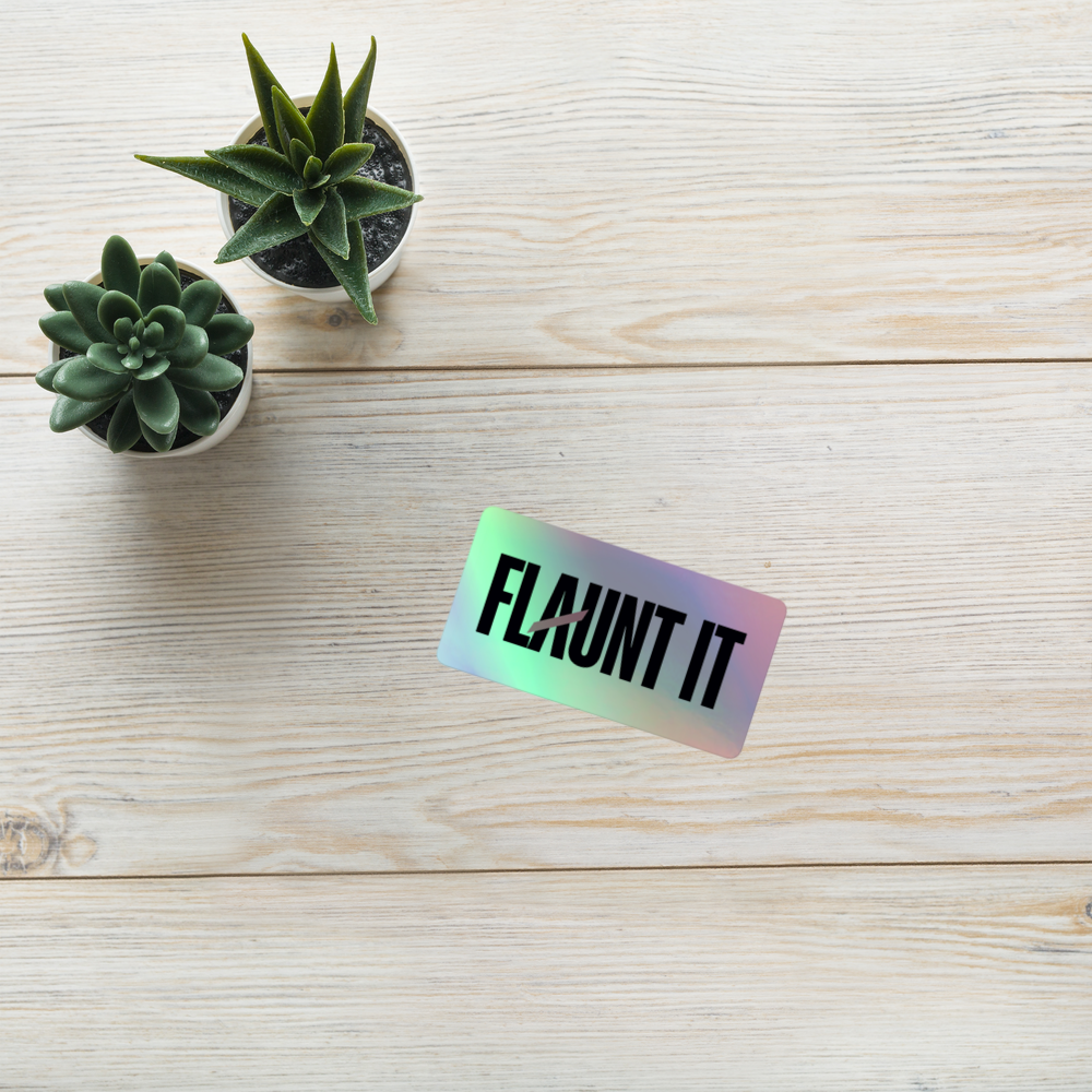 Flaunt It holographic vinyl logo sticker with 3D pattern on a white wooden surface with two small potted succulents.