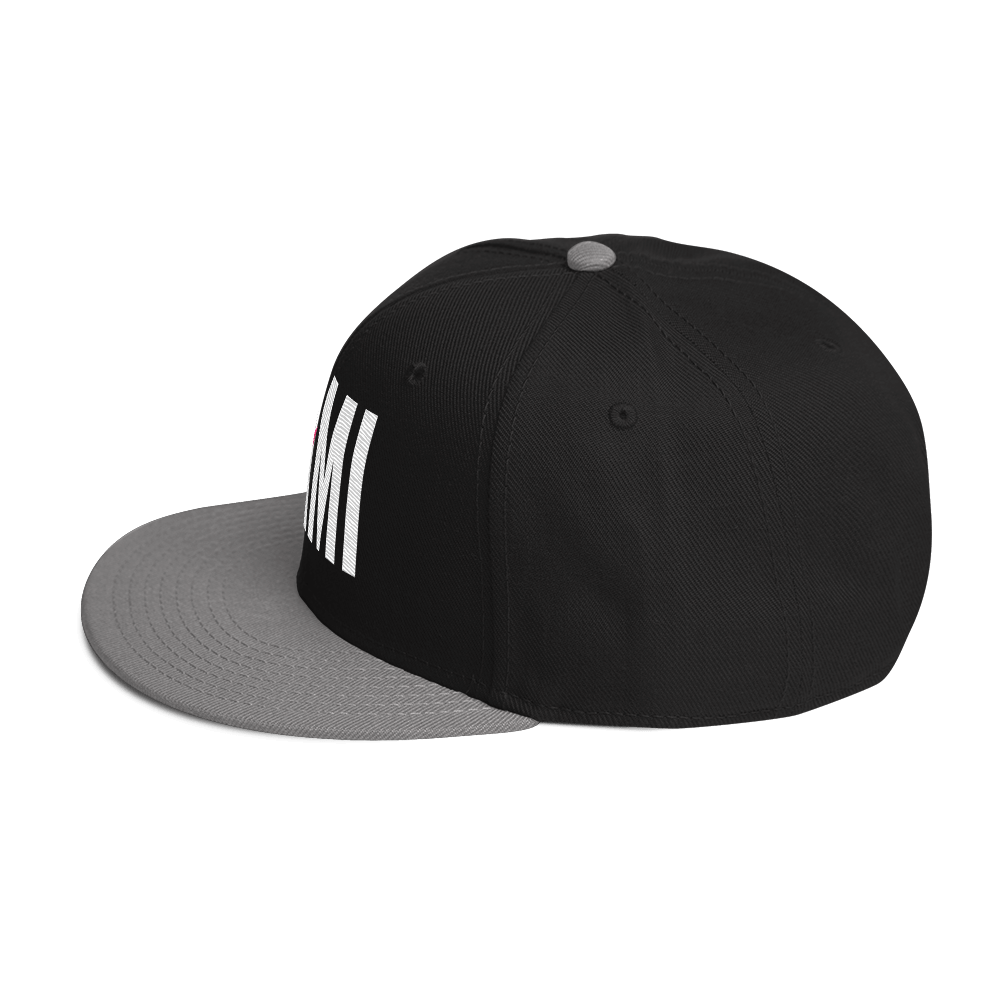 Flaunt It Mami embroidered black snapback hat with a grey flat brim and white stitched lettering.
