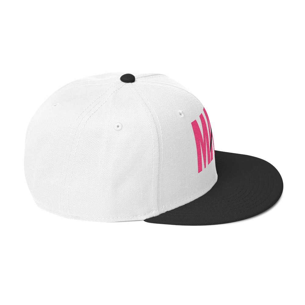 Flaunt It Mami embroidered snapback hat in white with a black brim and pink text featuring a diagonal slash design.