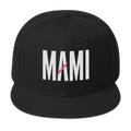 Flaunt It black structured snapback hat with white MAMI embroidery and a pink diagonal slash detail on the front.
