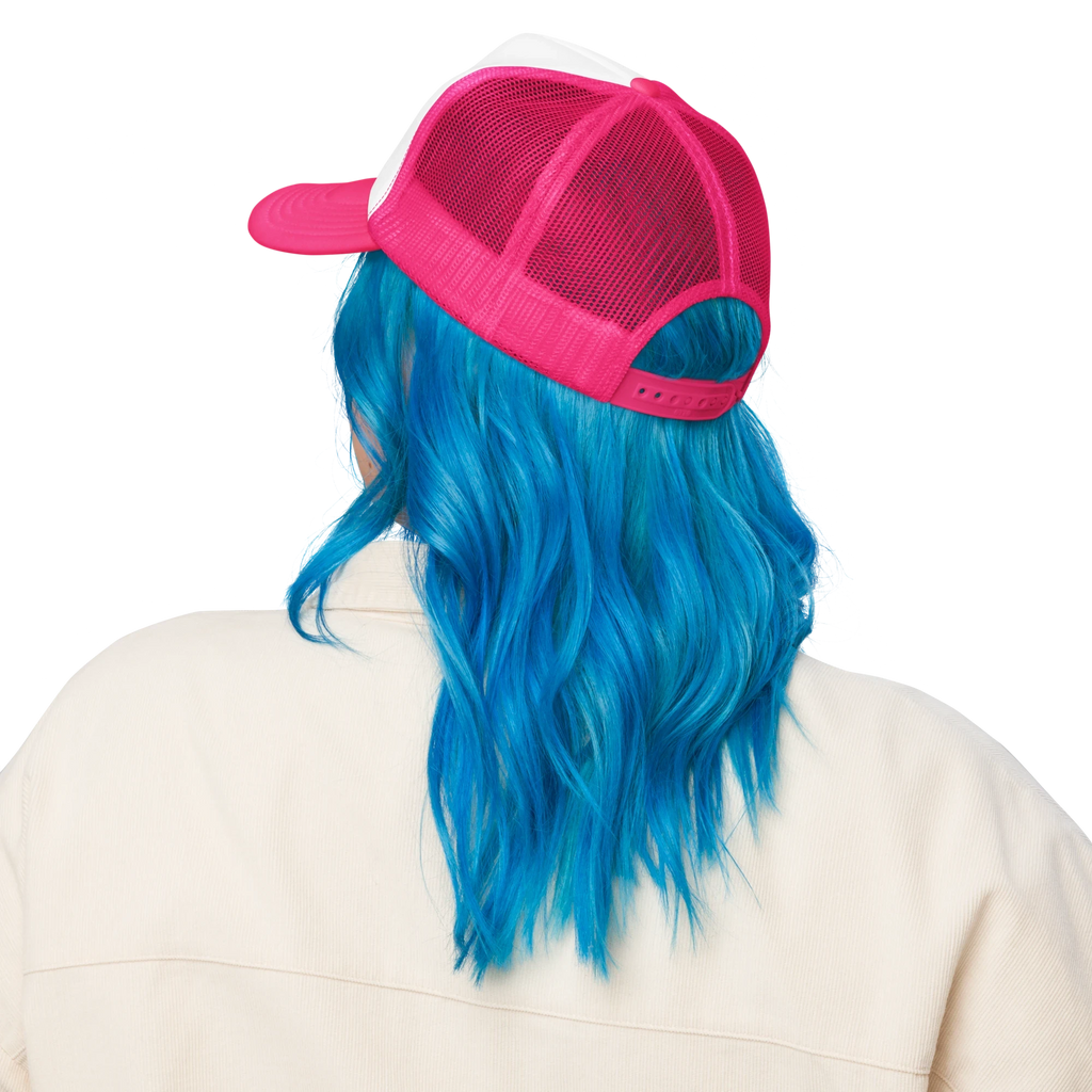 Flaunt It Mami premium unisex foam trucker hat in pink and white with mesh back, worn by a person with blue hair.