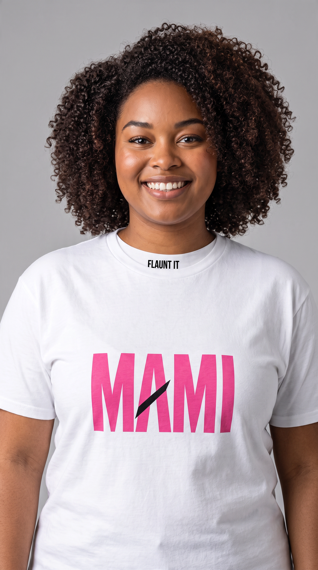 A woman wearing a Flaunt It white premium cotton unisex crew neck t-shirt with pink MAMI text and a diagonal slash.