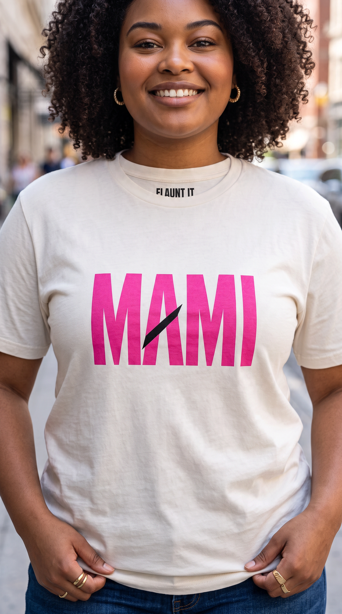 Flaunt It Mami premium unisex tee in off-white with bold pink MAMI text and a diagonal slash graphic