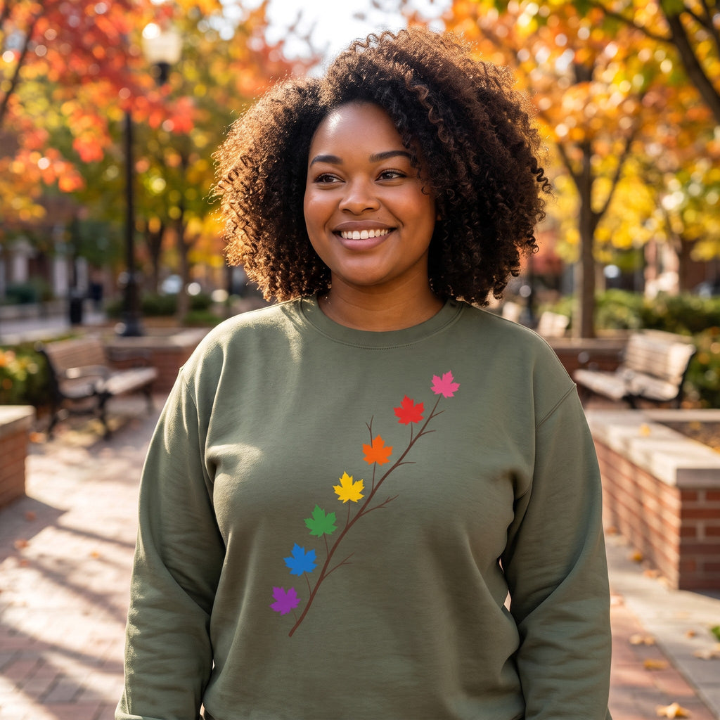 Flaunt It olive green heavyweight long sleeve shirt featuring a branch with rainbow pride maple leaves on a woman.