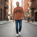 Flaunt It unisex heavyweight long sleeve shirt in rust orange with PAPI graphic and pink slash, worn by a man.