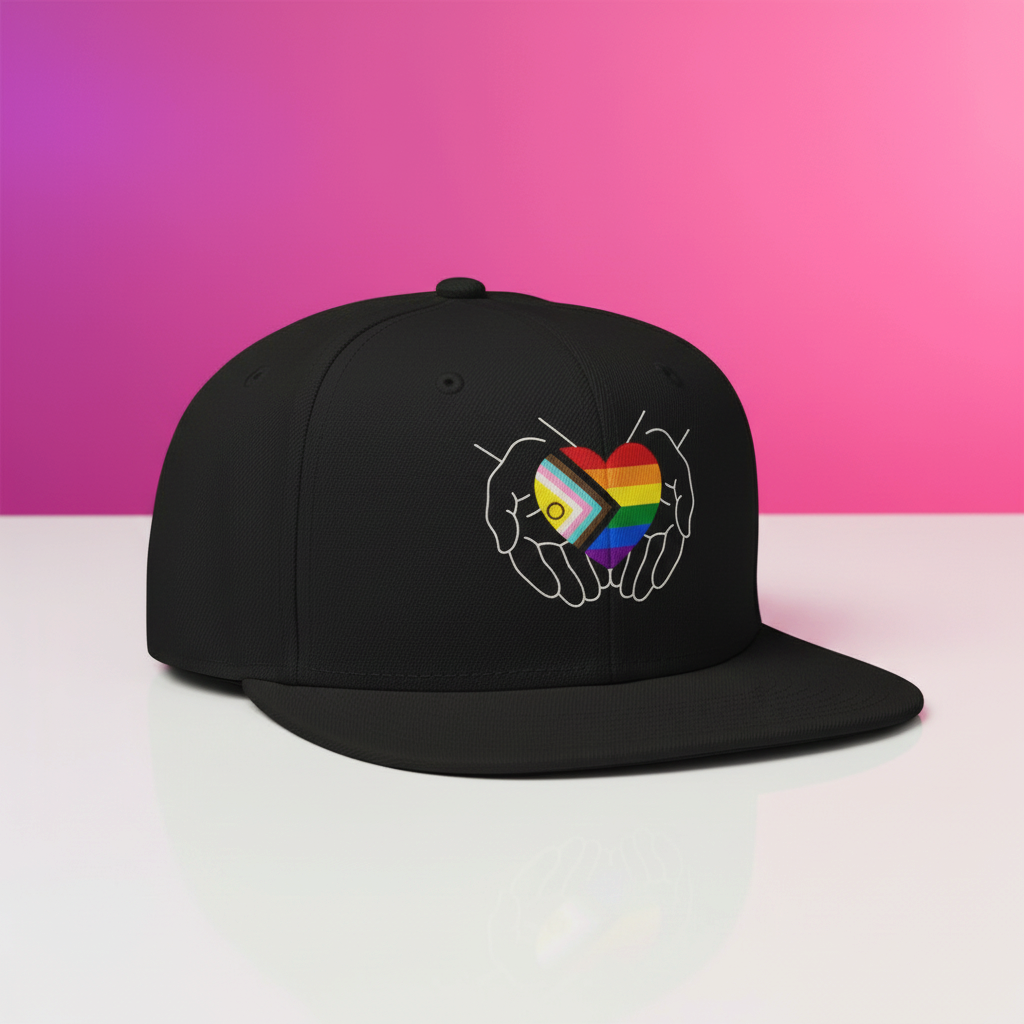 Flaunt It black structured snapback cap featuring a graphic of hands cradling an Intersex-Inclusive Progress Pride heart