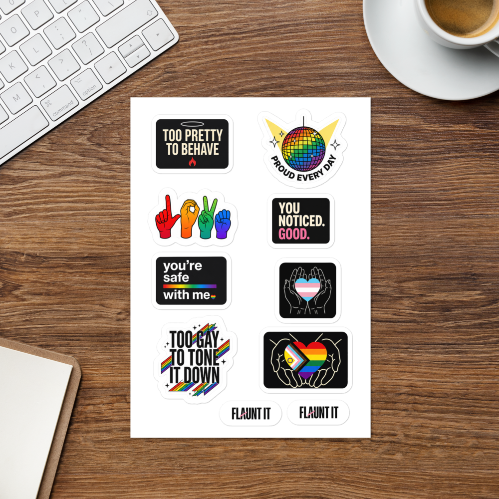Flaunt It Proud All Year sticker sheet featuring eight colorful LGBTQ+ themed glossy stickers on a wooden desk.