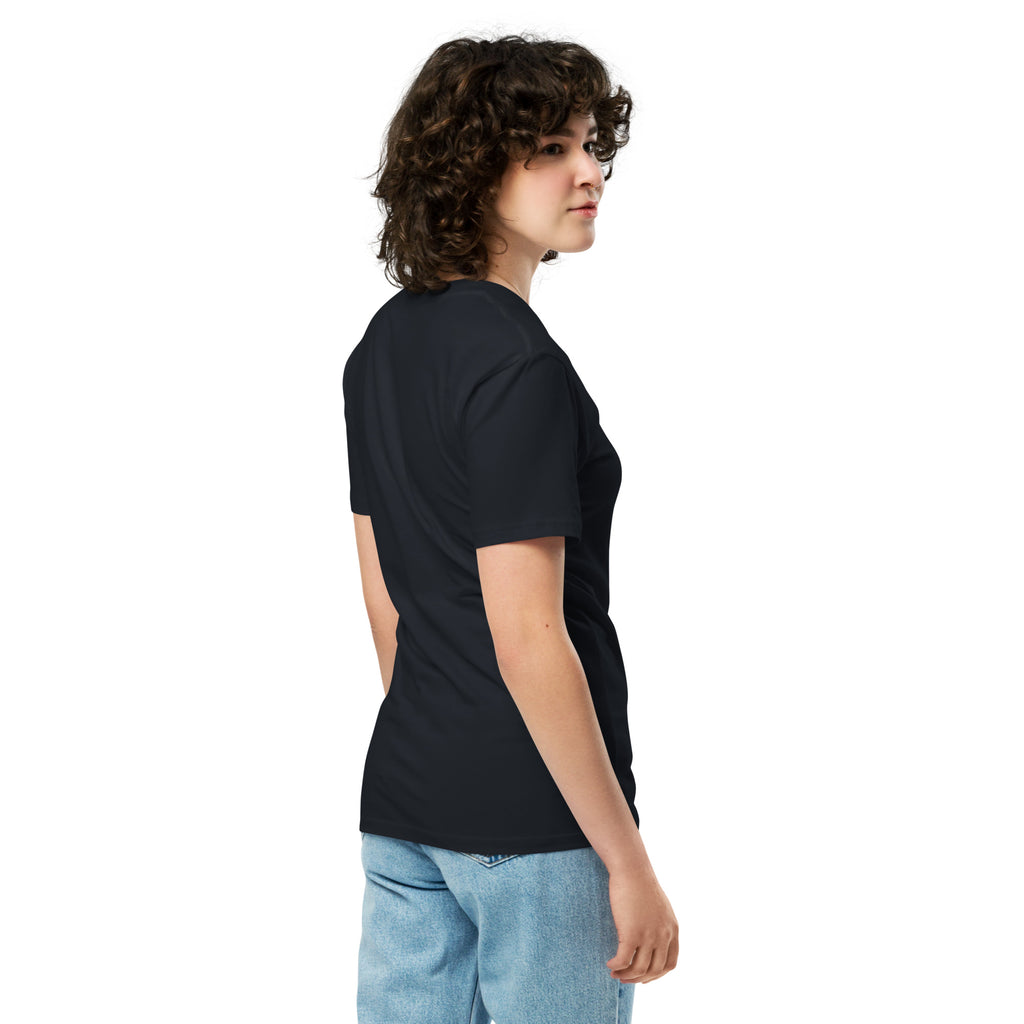 Right side view of a model wearing a navy blue San Visto premium unisex T-shirt with a devotional prayer-candle illustration of a male saint, pink SAN VISTO headline, red roses and a sacred heart.