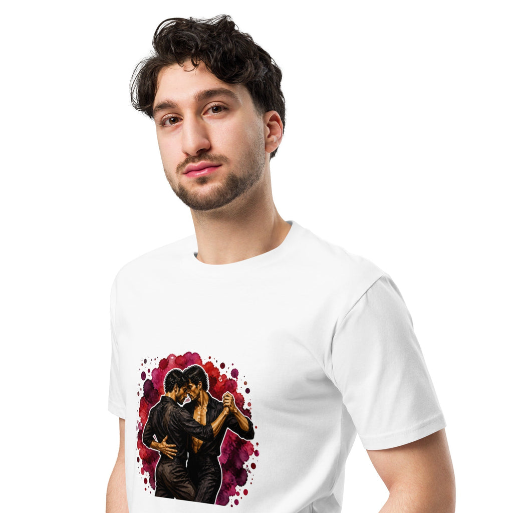 Three-quarter front view of a smiling model wearing a white Una Cancion Mas premium unisex T-shirt with a watercolor illustration of two women slow dancing against a magenta splash.